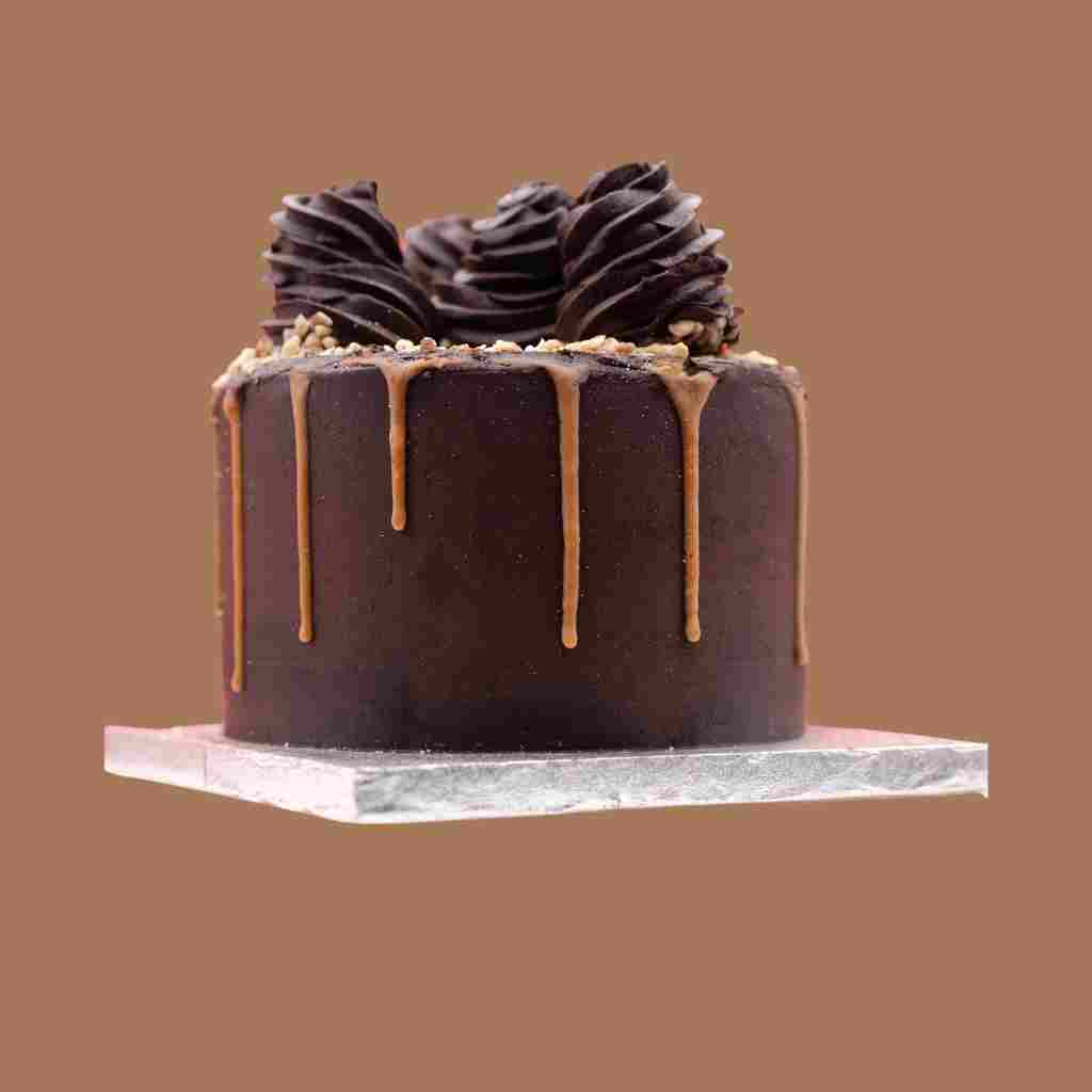 Chocolate keto birthday cake with caramel and chocolate icing.