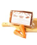 A low-carb package of Carrot Keto Cake Loaf with carrots on a cutting board. (Brand Name: No Guilt Bakes)