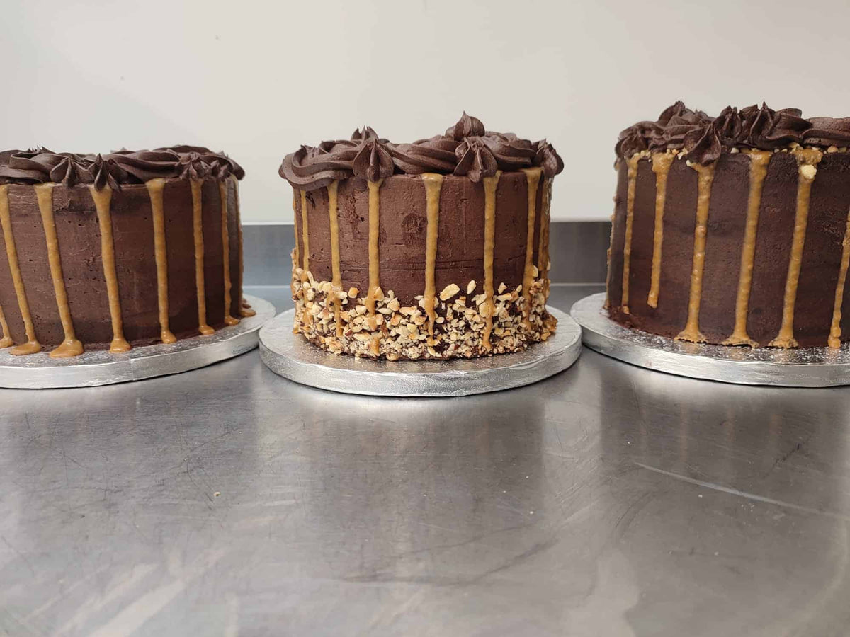 Three No Guilt Bakes custom made low sugar cakes sitting on top of a metal plate.