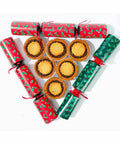 A group of No Guilt Bakes' Keto Mince Pies, with 6 pieces and no added sugars, and only containing 2.7 net carbs, are arranged in the form of triangular-shaped Christmas biscuits.