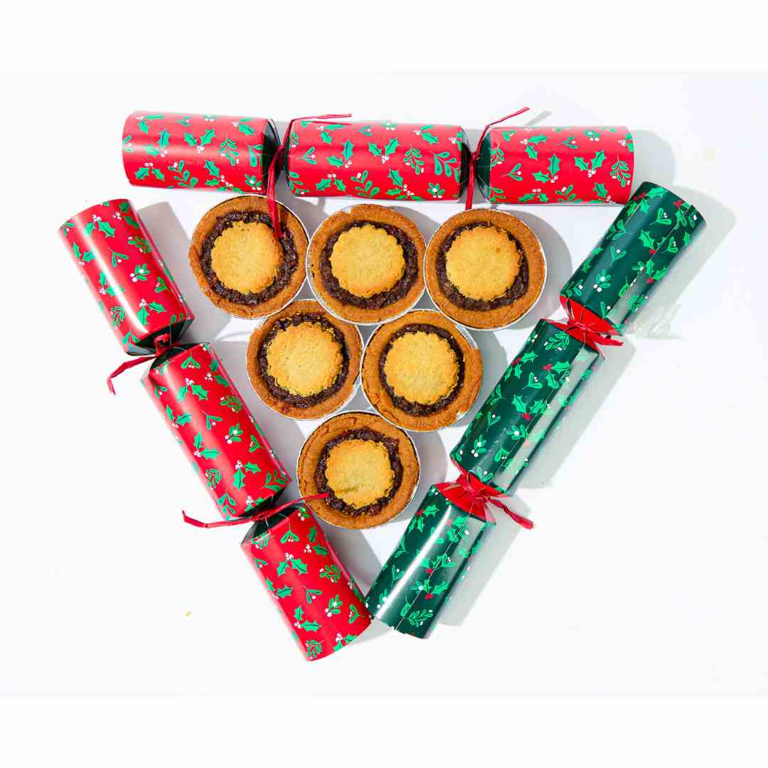 A group of No Guilt Bakes&#39; Keto Mince Pies, with 6 pieces and no added sugars, and only containing 2.7 net carbs, are arranged in the form of triangular-shaped Christmas biscuits.