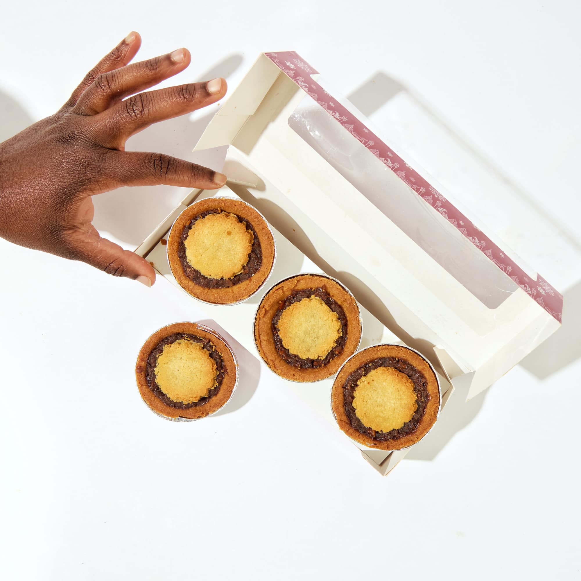 mince pies with hand reaching for it