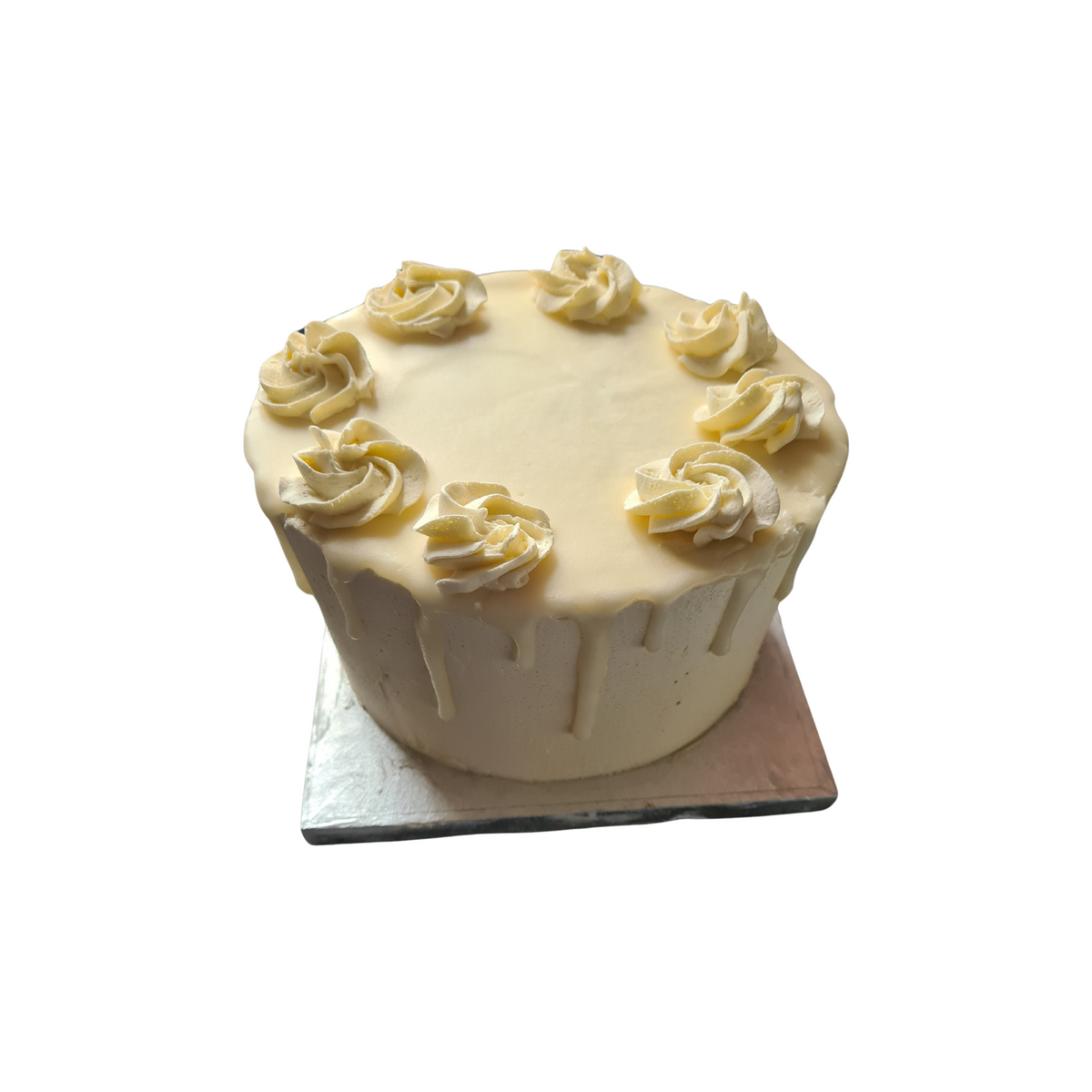 A white frosted, diabetic-friendly Vanilla Keto Birthday Cake with decorative piping on a silver base, isolated on a white background from No Guilt Bakes.